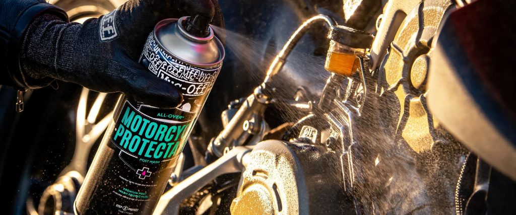 Cire moto en spray appliquée sur le moteur d'une moto